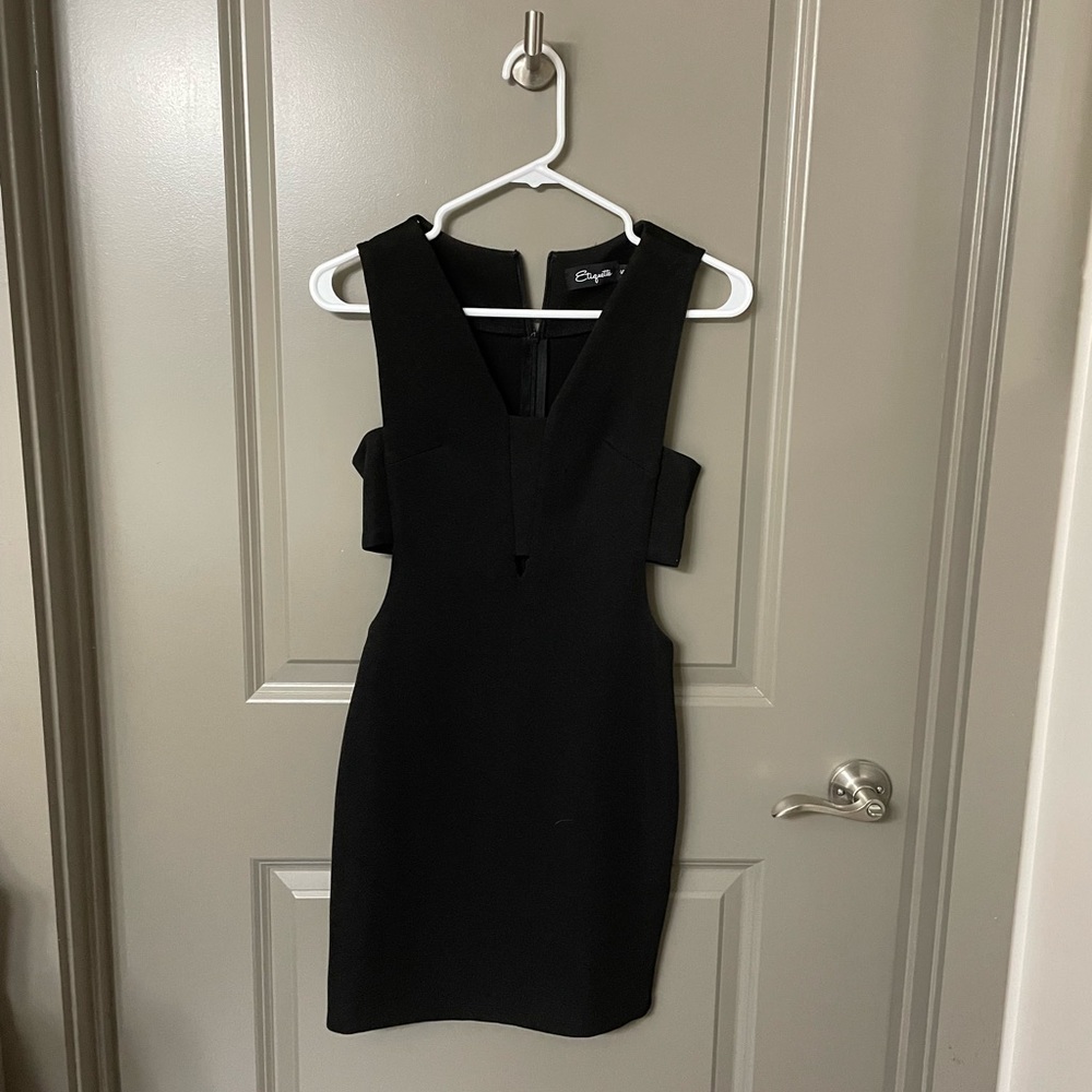 Black cocktail dress, with cute cutout detail. Worn once! Size small.